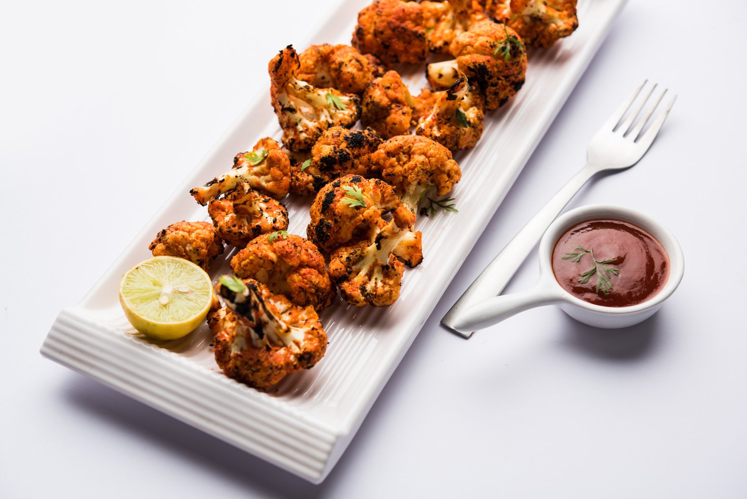 Tandoori Gobi / Roasted cauliflower Tikka is a starter food from India. served with ketchup. selective focus